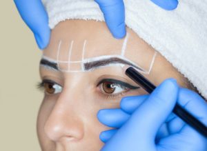 Woman getting permanent eyebrows cosmetic procedure