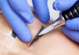 Woman getting permanent eyeliner cosmetic procedure