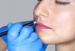 Woman getting permanent makeup for her lips