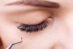 Closeup of Eyelash Extensions Being Applied to a Woman's Eye