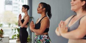 Three young women meditating during a yoga class, meditation-changes-your-body