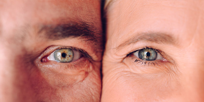 Close-up of a man’s face next to a woman’s face, both with crow’s feet