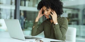 A young woman experiencing stress and anxiety at work