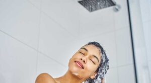 A woman shampooing her hair in the shower