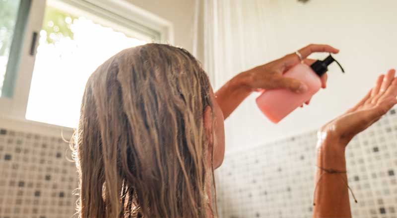 A woman washing her hair in the shower
