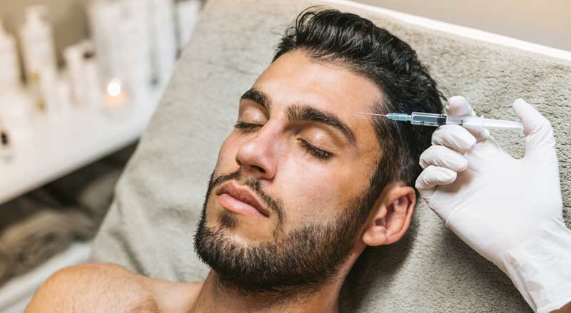 A man is receiving a Botox Cosmetic injection